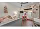Bright bedroom with hardwood floors, ceiling fan, and decorated with a collection of toys at 2711 W Trilby Ave, Tampa, FL 33611
