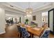 Elegant dining room with hardwood floors, stylish chandelier, and an open view into the living spaces at 2711 W Trilby Ave, Tampa, FL 33611
