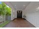 Covered entrance with a modern tile wall and a dark wood front door at 2711 W Trilby Ave, Tampa, FL 33611