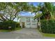 Beautiful modern home with lush landscaping, large trees and a two-car garage at 2711 W Trilby Ave, Tampa, FL 33611