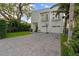 Contemporary white home featuring a two-car garage and well-kept landscaping at 2711 W Trilby Ave, Tampa, FL 33611