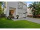 Modern home with a manicured lawn, two-car garage and balcony at 2711 W Trilby Ave, Tampa, FL 33611