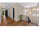 Bright hallway with hardwood floors, elegant chandelier and staircase, creating a welcoming and stylish entrance at 2711 W Trilby Ave, Tampa, FL 33611
