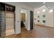 Hallway featuring an elevator and an open door to a half bathroom with decorative accent wall at 2711 W Trilby Ave, Tampa, FL 33611