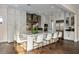 Modern kitchen with white cabinets, a marble island with seating, and stainless steel appliances at 2711 W Trilby Ave, Tampa, FL 33611
