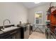 Modern laundry room featuring updated appliances and cabinet space at 2711 W Trilby Ave, Tampa, FL 33611