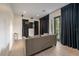 Comfortable living room with hardwood floors, recessed lighting, black-out curtains, and back patio access at 2711 W Trilby Ave, Tampa, FL 33611
