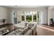 Inviting living room with a plush sofa, hardwood floors, and large sliding doors leading to the outdoor space at 2711 W Trilby Ave, Tampa, FL 33611