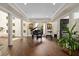 Open-concept living space with a grand piano, modern fireplace, and stylish décor at 2711 W Trilby Ave, Tampa, FL 33611
