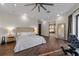 Bright main bedroom boasts hardwood floors, a cozy seating area, and an en-suite bathroom, creating a peaceful retreat at 2711 W Trilby Ave, Tampa, FL 33611