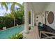 Outdoor patio with a pool, columns, outdoor seating, and lush landscaping at 2711 W Trilby Ave, Tampa, FL 33611