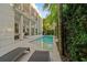 Inviting backyard pool area features lush landscaping and a spacious patio for outdoor relaxation and entertaining at 2711 W Trilby Ave, Tampa, FL 33611
