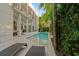 An inviting pool with lounge chairs that is surrounded by lush greenery offering a serene outdoor living experience at 2711 W Trilby Ave, Tampa, FL 33611