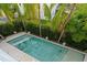 This aerial view showcases the pool area, highlighting the lush landscaping and surrounding greenery at 2711 W Trilby Ave, Tampa, FL 33611