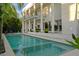 A stunning waterfront home featuring a private pool, palm trees, and a spacious outdoor area for relaxation and entertainment at 2711 W Trilby Ave, Tampa, FL 33611