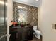 Stylish powder room with a granite countertop and eye-catching mirror at 2711 W Trilby Ave, Tampa, FL 33611