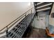Modern staircase with sleek metal railings and a unique wine display, adding a touch of sophistication to the home at 2711 W Trilby Ave, Tampa, FL 33611