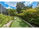 Fun backyard putting green with lush landscaping, perfect for outdoor recreation at 2800 Resnik W Cir, Palm Harbor, FL 34683