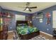 Blue bedroom with dark furniture, ceiling fan, and themed decor at 2800 Resnik W Cir, Palm Harbor, FL 34683
