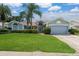 Inviting single-Gathering home with manicured lawn, mature landscaping, and an attached two-car garage at 2800 Resnik W Cir, Palm Harbor, FL 34683