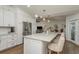 Spacious kitchen with a marble countertop island, white cabinets, and stainless steel appliances at 2800 Resnik W Cir, Palm Harbor, FL 34683