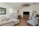 Bright living room featuring hardwood floors, comfortable seating, and a large window with natural light at 2800 Resnik W Cir, Palm Harbor, FL 34683
