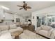 Open-concept living room leads to bright kitchen with island and seating, and access to outside patio at 2800 Resnik W Cir, Palm Harbor, FL 34683