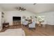 Open-concept living and dining area with modern furnishings, wood floors, and vaulted ceilings at 2800 Resnik W Cir, Palm Harbor, FL 34683