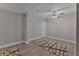 Bedroom with ceiling fan, wood-look flooring, and neutral paint at 2812 Tom Brewer Ln, Plant City, FL 33566