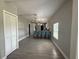 Open dining space with modern lighting and seating, leading into a well-lit kitchen area at 2812 Tom Brewer Ln, Plant City, FL 33566
