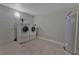 Tiled laundry room with washer, dryer, and storage space at 2812 Tom Brewer Ln, Plant City, FL 33566