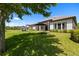 Lush backyard with an umbrella-shaded seating area and manicured landscaping at 2839 Cordoba Ranch Blvd, Lutz, FL 33559