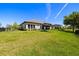 Fenced backyard has a lush lawn with an outdoor kitchen and seating area at 2839 Cordoba Ranch Blvd, Lutz, FL 33559