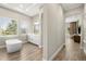 Bright bathroom featuring a soaking tub, tiled floor, and a bright window at 2839 Cordoba Ranch Blvd, Lutz, FL 33559