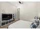 Bedroom with a large television on a shelving unit, and ensuite doorway at 2839 Cordoba Ranch Blvd, Lutz, FL 33559