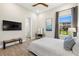 Bedroom featuring a ceiling fan, decor, ensuite bathroom and exterior views at 2839 Cordoba Ranch Blvd, Lutz, FL 33559