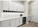 Elegant butler's pantry with wine storage, white cabinetry, and stylish countertop at 2839 Cordoba Ranch Blvd, Lutz, FL 33559