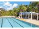 View of community pool area features ample lounge seating, shade structures, and lush landscaping at 2839 Cordoba Ranch Blvd, Lutz, FL 33559