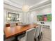 Bright dining room featuring a large wood table, white chairs, and modern decor at 2839 Cordoba Ranch Blvd, Lutz, FL 33559