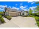Home exterior displaying a multi-car garage and tidy landscaping at 2839 Cordoba Ranch Blvd, Lutz, FL 33559