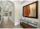 Hallway with modern art and recessed lighting, leading to sunlit living spaces at 2839 Cordoba Ranch Blvd, Lutz, FL 33559