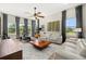 Bright living room with large windows, a ceiling fan, comfortable seating, and a home gym area at 2839 Cordoba Ranch Blvd, Lutz, FL 33559
