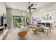 Open-concept living room featuring a ceiling fan, large windows, and seamless flow to the kitchen at 2839 Cordoba Ranch Blvd, Lutz, FL 33559