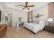 Spacious main bedroom featuring wood floors, a ceiling fan, and elegant furniture at 2839 Cordoba Ranch Blvd, Lutz, FL 33559