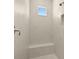 Modern shower featuring white marble-look tiles and a built-in bench at 2839 Cordoba Ranch Blvd, Lutz, FL 33559