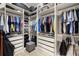 Spacious walk-in closet with custom shelving, drawers, and ample storage space for clothes and accessories at 2839 Cordoba Ranch Blvd, Lutz, FL 33559