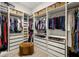 Large walk-in closet featuring custom organizers, built-in shelving, drawers, and a comfortable seating area at 2839 Cordoba Ranch Blvd, Lutz, FL 33559