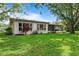 This backyard has an abundance of green space, lush landscaping and a back lanai at 2875 Lomond Dr, Palm Harbor, FL 34684