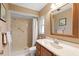 Bathroom featuring walk-in shower with white tile, grab bar, and wood vanity at 2875 Lomond Dr, Palm Harbor, FL 34684