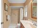Bathroom featuring walk-in shower with white tile, grab bar, and wood vanity at 2875 Lomond Dr, Palm Harbor, FL 34684
